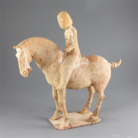 A Chinese polychrome painted pottery group of a horse and rider, Tang dynasty or later, height 36.5cm